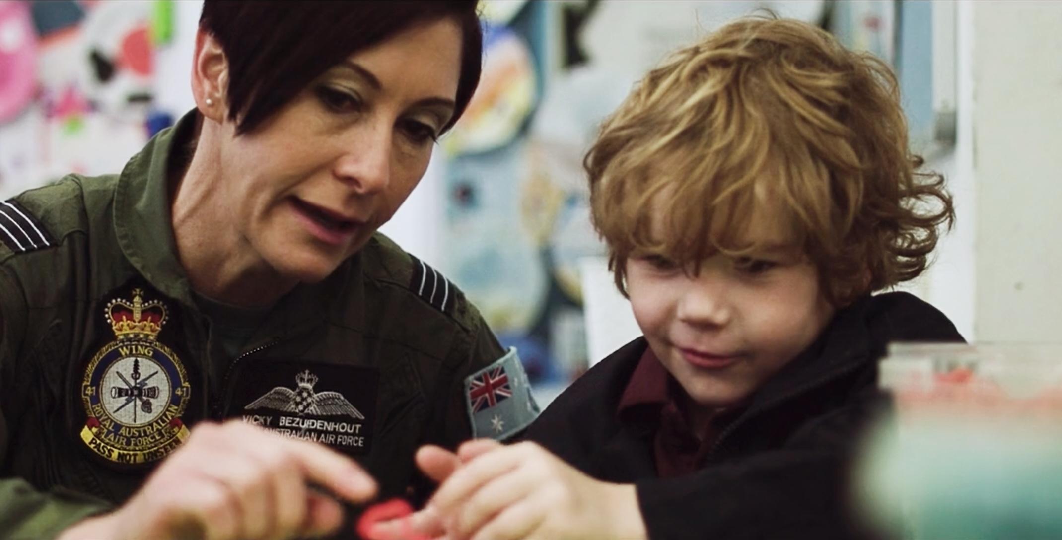 A Defence Force member engaging with a young student at Medowie Christian School as part of the Defence Support Program.