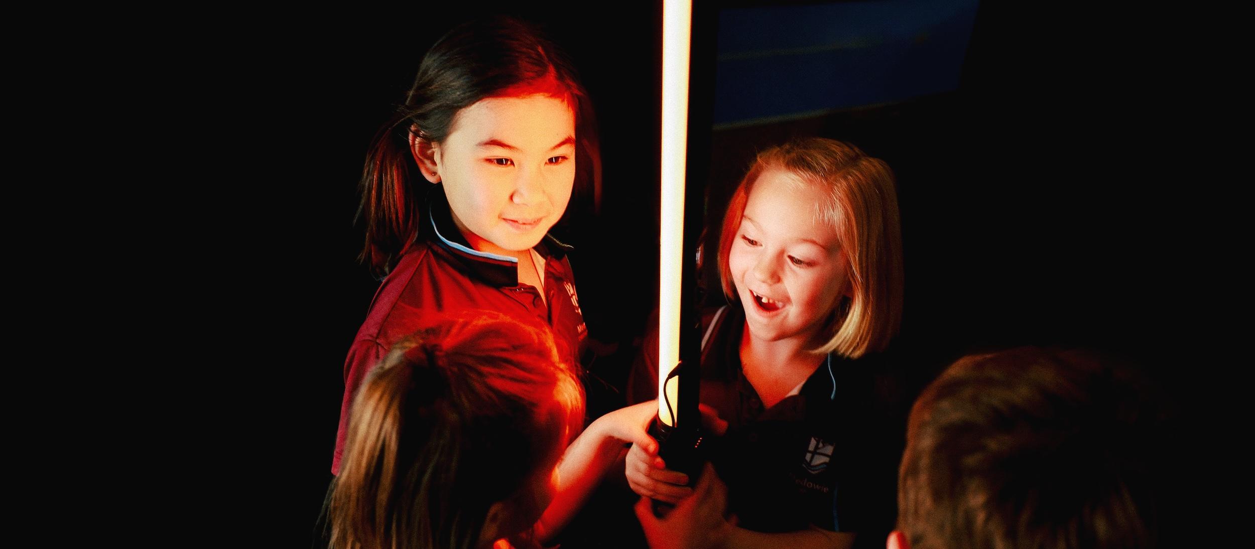 Young students at Medowie Christian School exploring a light experiment in an interactive learning approach.