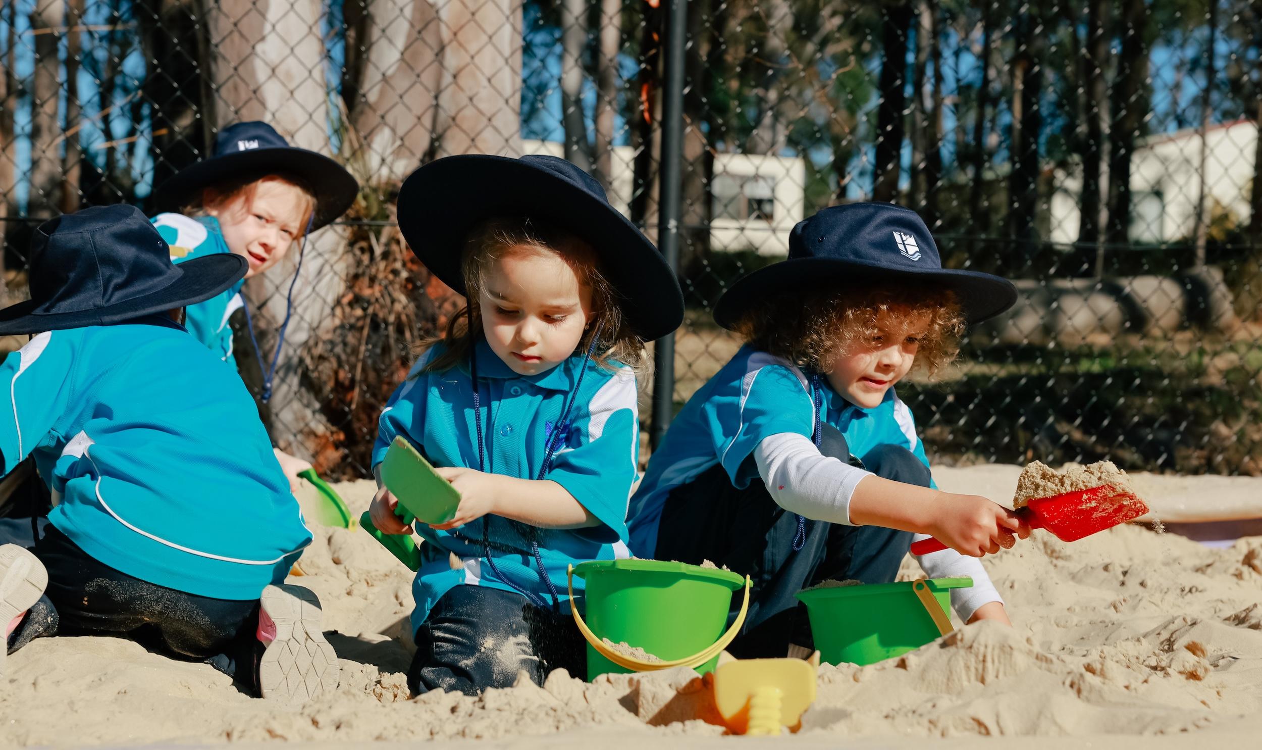 Group of prep students engaged in creative play in the sandpit at Medowie Christian School.