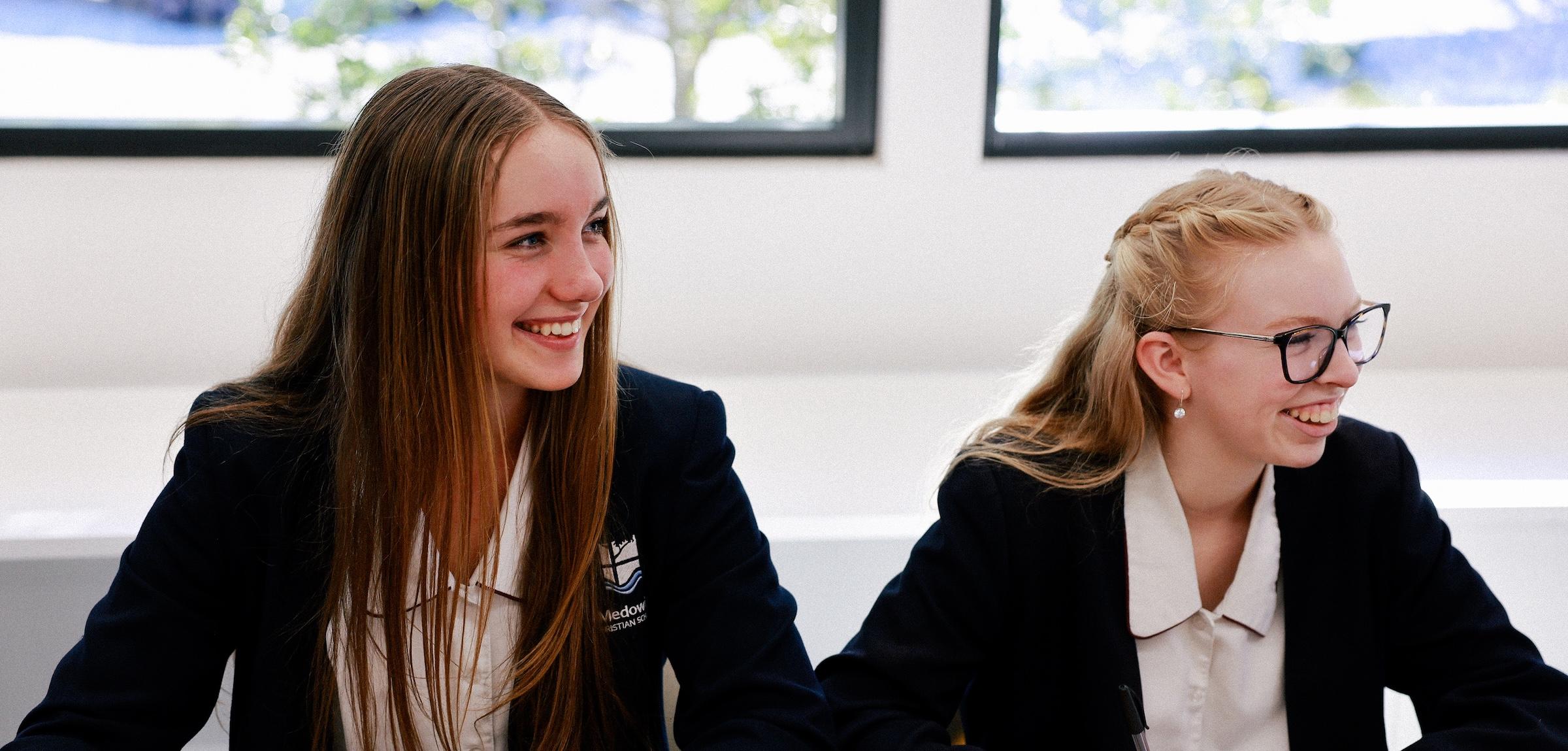 Two students engaged and smiling during a classroom discussion at Medowie Christian School.